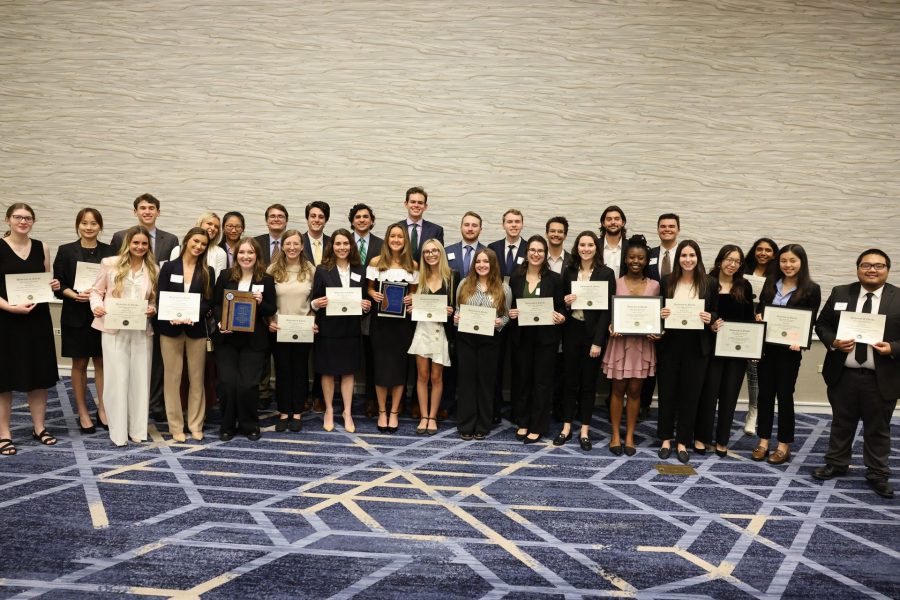 Fisher School of Accounting students holding awards.