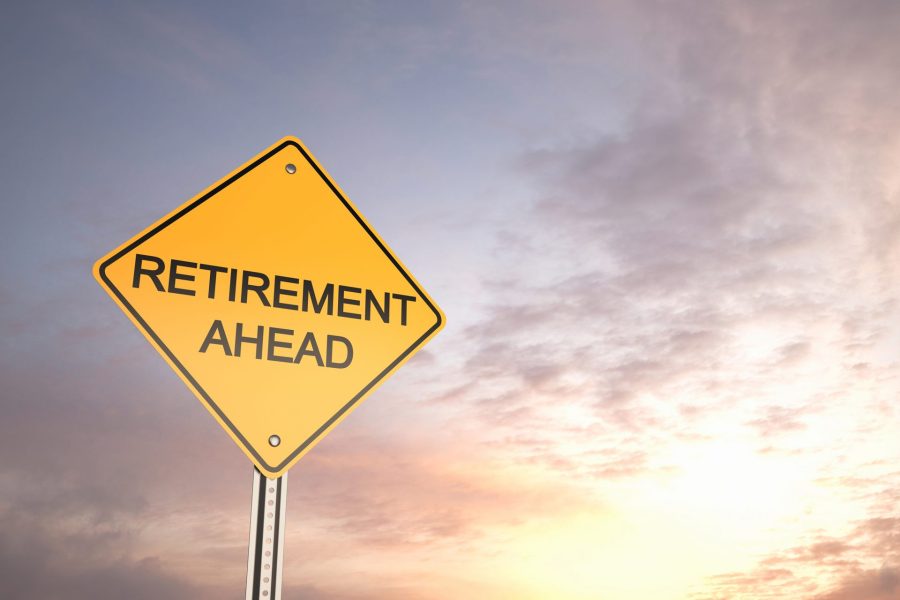 A road sign stating 'Retirement Ahead' and in the background a setting sun