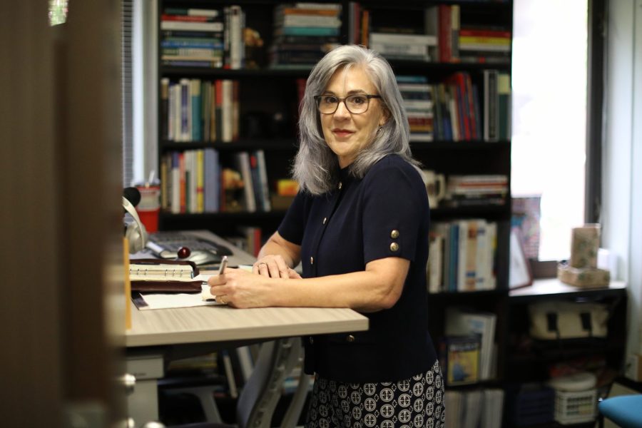 Judy Callahan stands at her desk.