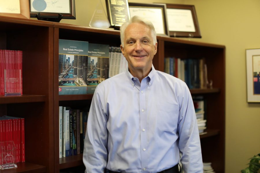 David Ling stands in front of a bookcase in his office.