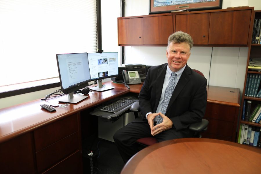 Joel Houston sitting at his computer in his office.