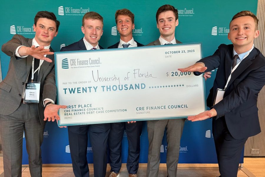 Five students hold a large check for $20,000.