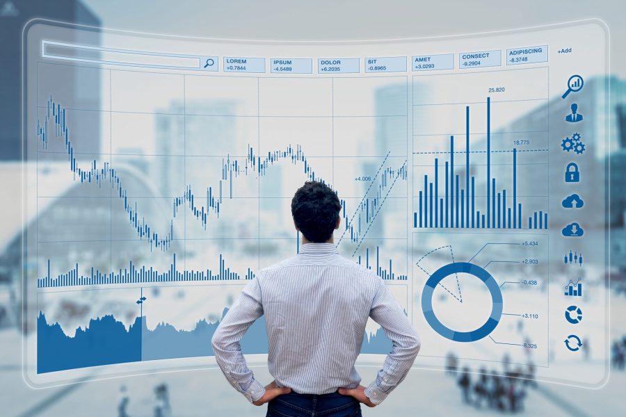 Finance trade manager analyzing stock market indicators for best investment strategy, financial data and charts with business buildings in background.