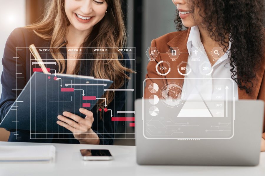 Two young women planning with milestones progress