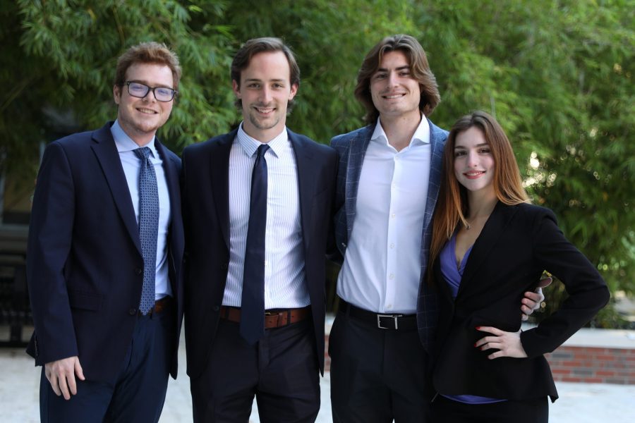 Four students pose for a group photo.