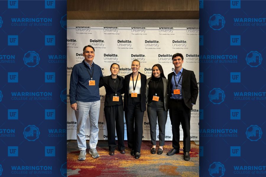 Students pose for a photo with their faculty advisor.