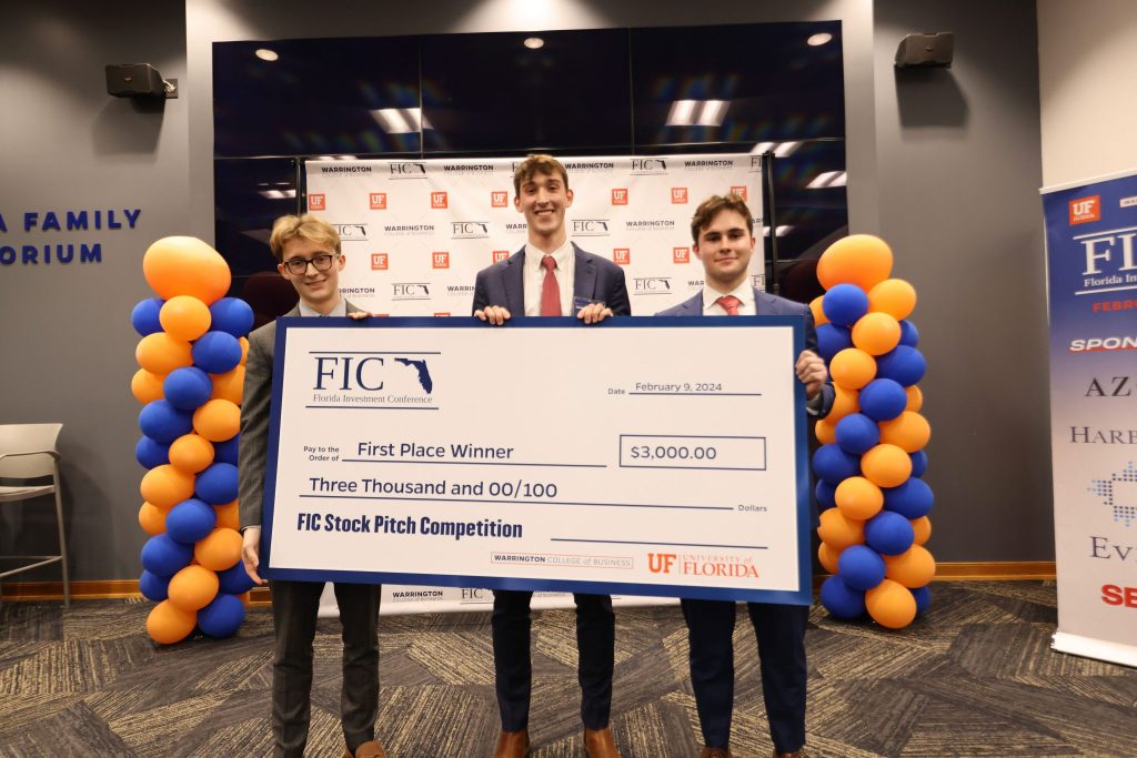 FIC first place winners hold a giant check for $3000