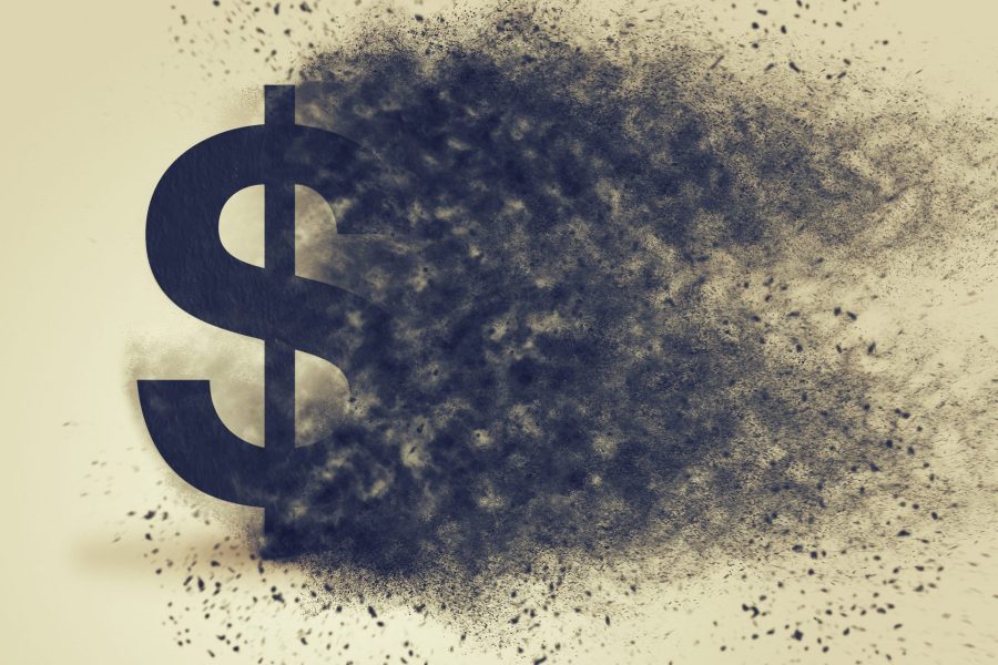 Dollar sign exploding and dissolving, concept of currency devaluation and inflation