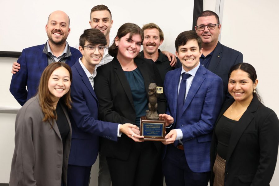 Winning team displays trophy with Baker Hughes representatives.