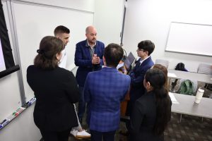 Judges consult with a team of students.