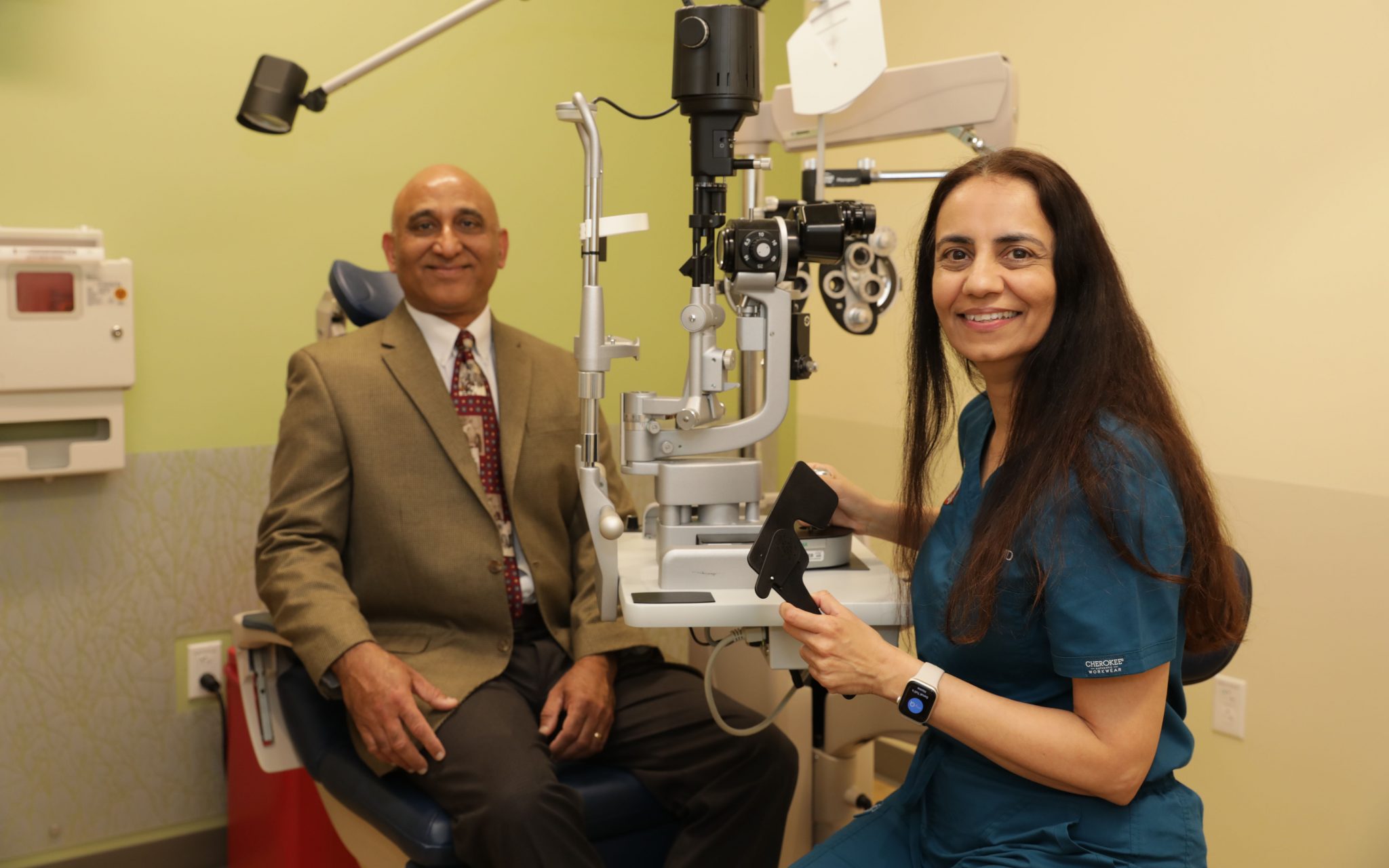Sonal Tuli gives her husband Sanjeev Tuli an eye exam.