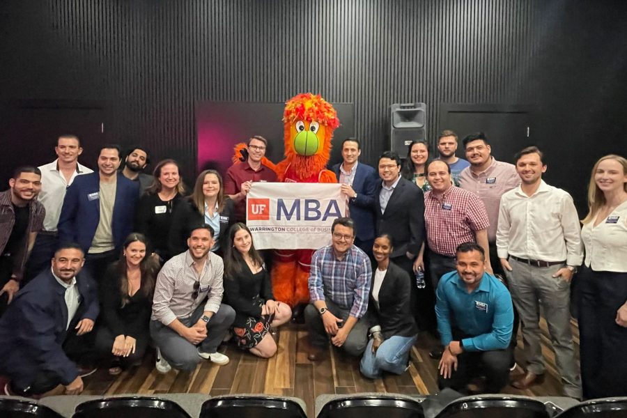 A large group of students pose for a photo with Burnie, the Miami Heat mascot