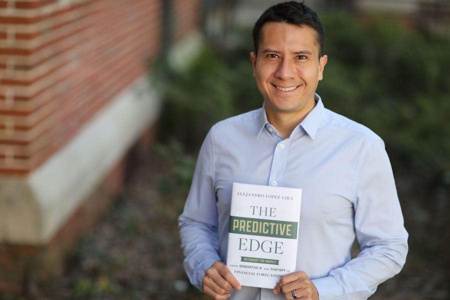 Alejandro Lopez-Lira holding his book, The Predictive Edge.