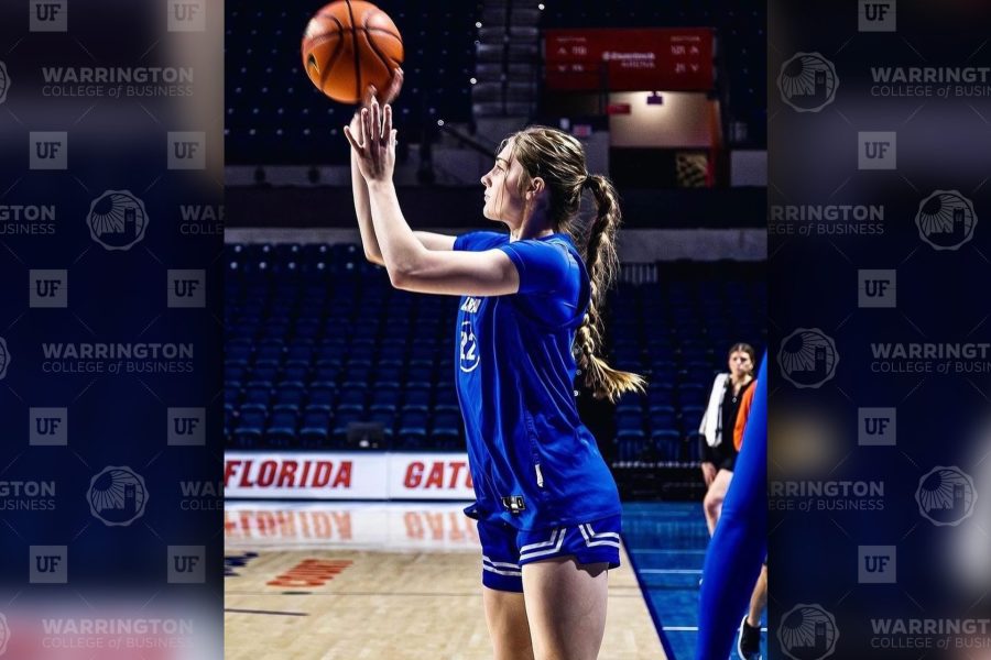 Paige Clausen taking a basketball shot on the court.