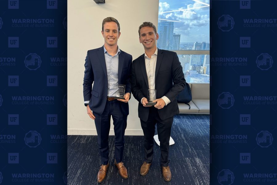 Jordi Triulzi and Eric Minsky pose with their winning trophies after winning the 2024 Rialto Florida Case Competition