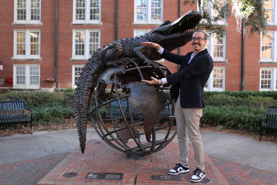Trevor Foulk does the Gator chomp with GUS sculpture.