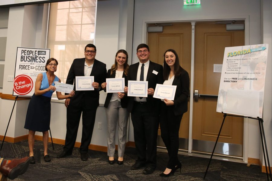 Kristin Joys and four students each holding certificates