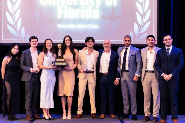 John Molson Undergraduate Case Competition team on stage with the trophy