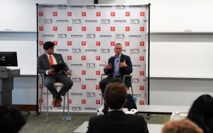 Ian Lane speaks with students at the Florida Investment Conference with a student interviewer.