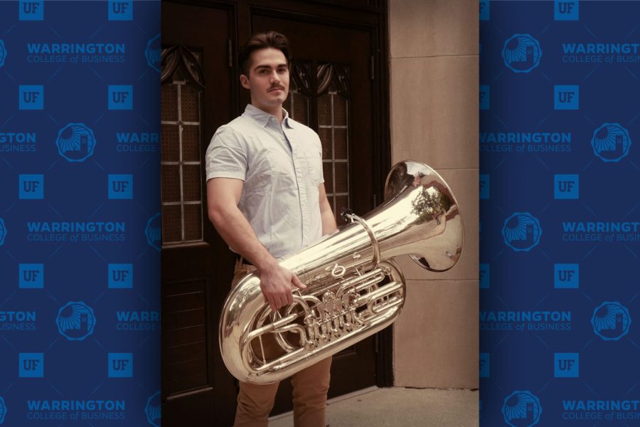 Luke Plugge holds a tuba