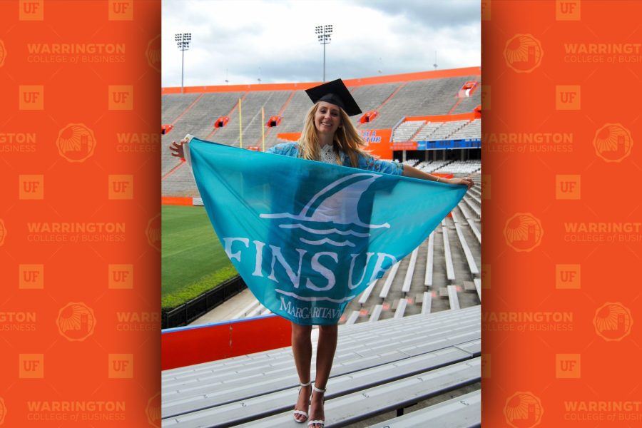 kristina genovese with fins up margaritaville flag in the UF football stadium