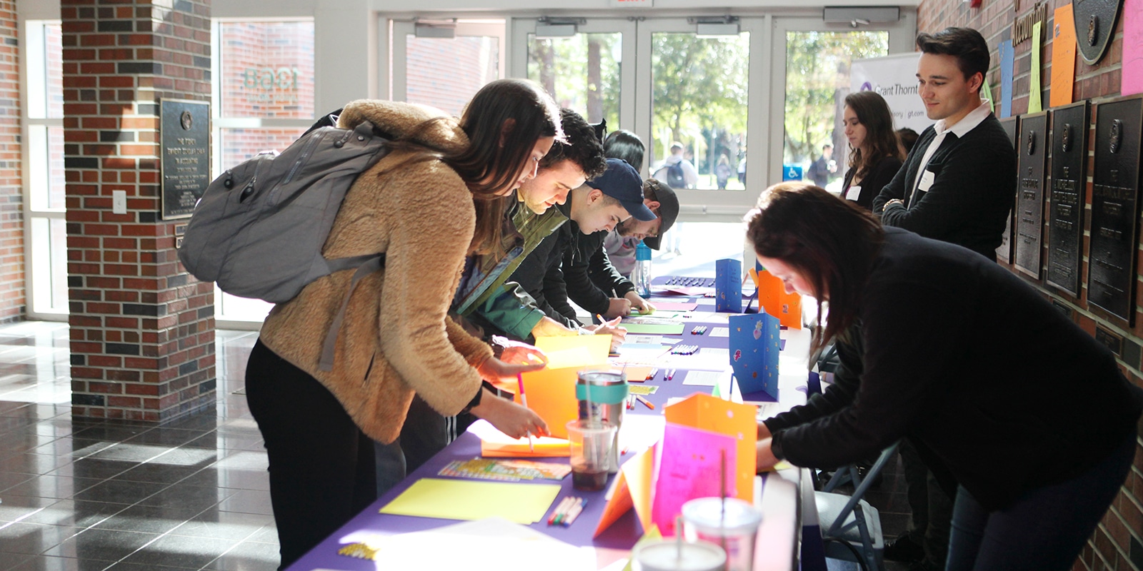 BS in Accounting students look at brochures from a recruiter set up in UF Warrington's Fisher School of Accounting