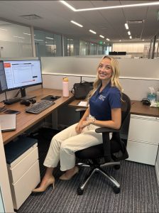 Emma Glazener (BSAc ’25) sitting at her desk at Berokwitz Pollack Brant.