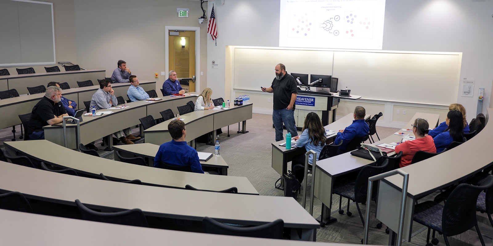 An instructor talks about systems and data storage models to a classroom of UF Warrington MS in Information Systems and Operations Management students