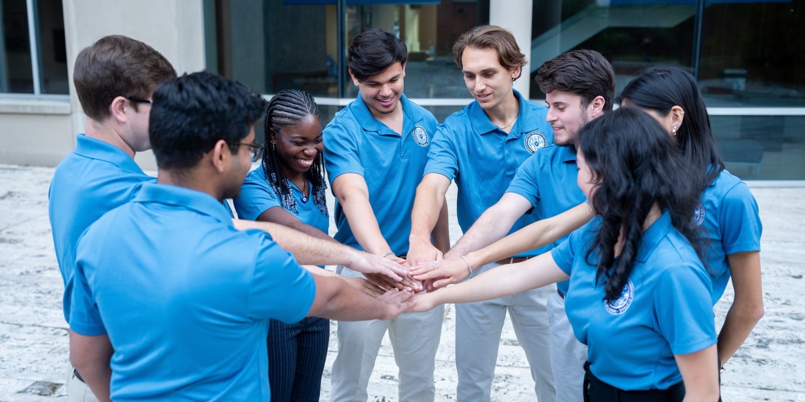 Students from the University of Florida's Association for Information Systems wearing blue shirts and gray pants