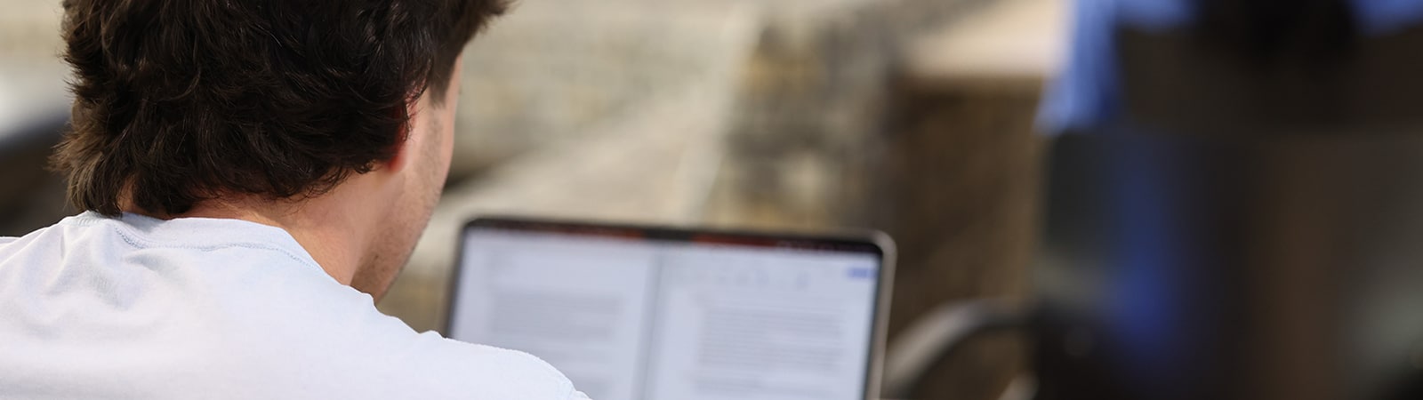 A student from the University of Florida Warrington College of Business' Online MSM program reviews notes on a tablet