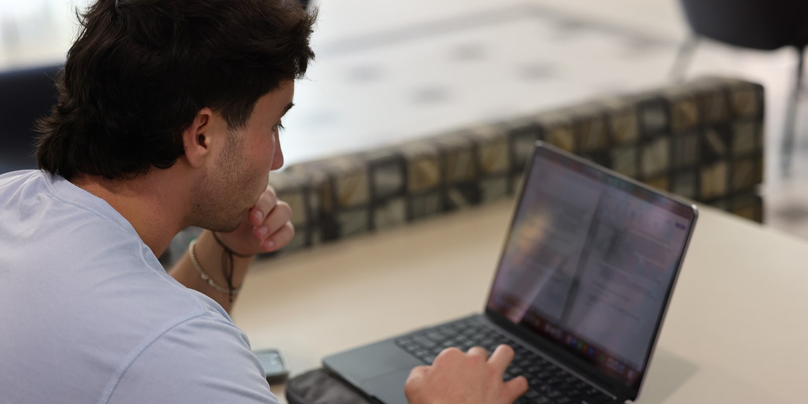 A student from UF Warrington's Online MS Marketing program reviews mined data on the screen of a tablet