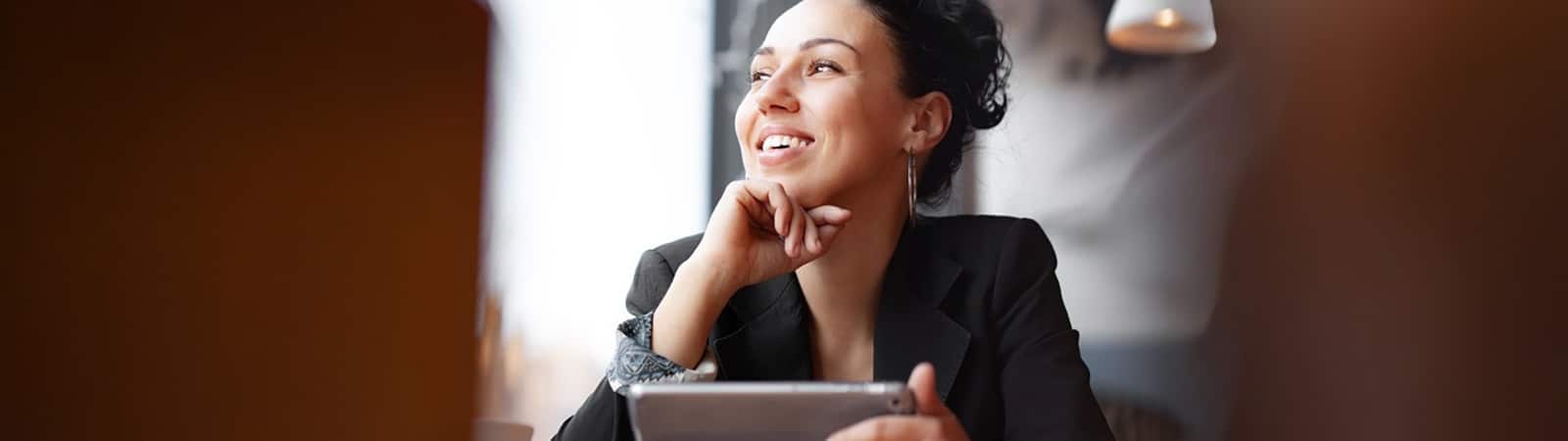 A student enrolled in the University of Florida Warrington College of Business' Online Master of International Business program looks in the distance while using a tablet
