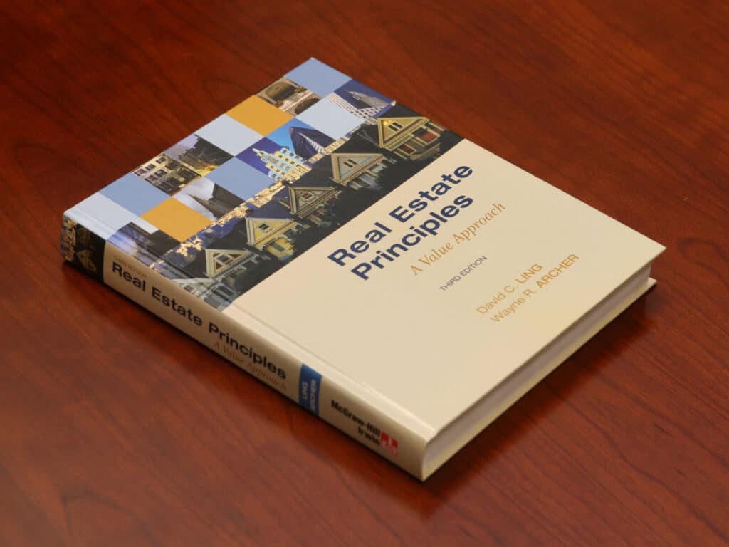 A book on a table: Real Estate Principles: A Value Approach, Third Edition, David C. Ling, Wayne R. Archer