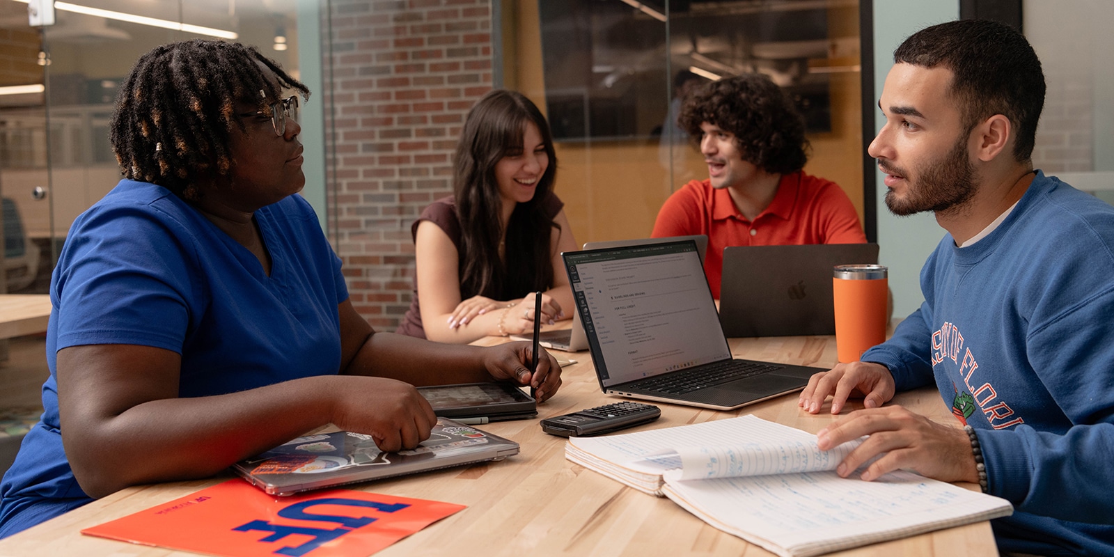 Students meeting at a table. 