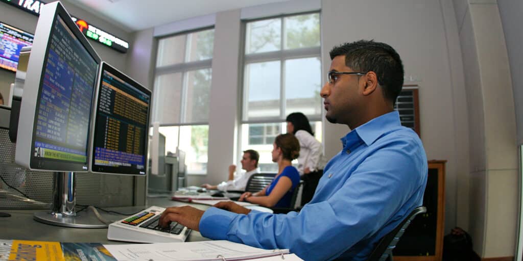 A student in UF Warrington's BSBA in Finance program reviews financial data on a computer monitor