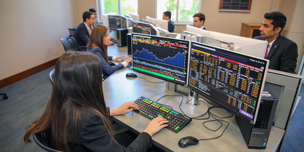 UF Warrington students participating in the Gator Student Investment Fund review finance data on computer screens to make portfolio recommendations