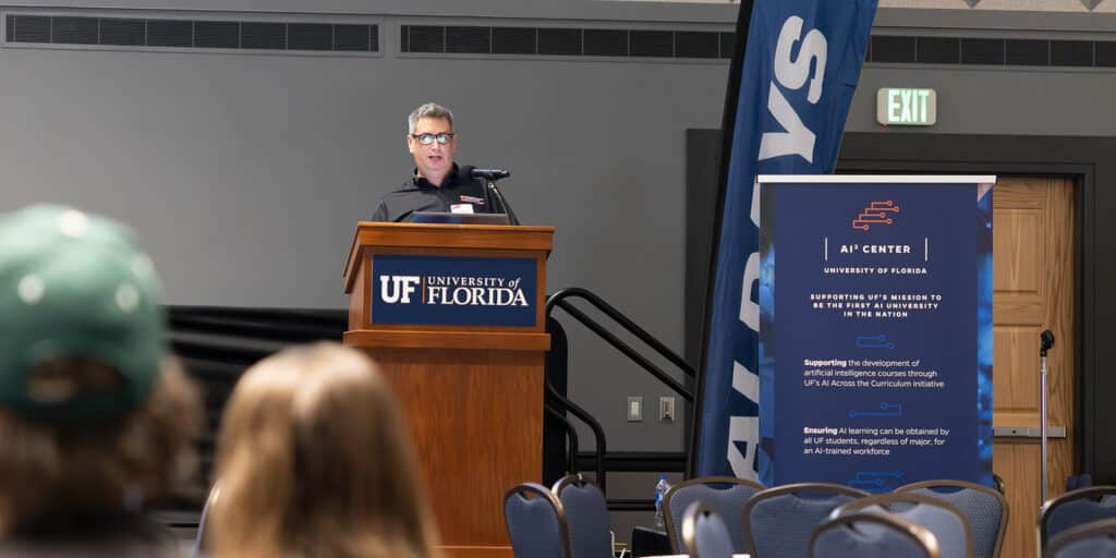 A faculty member speaks from behind a podium to a group of BSBA in Marketing students about UF Warrington's data and AI initiatives