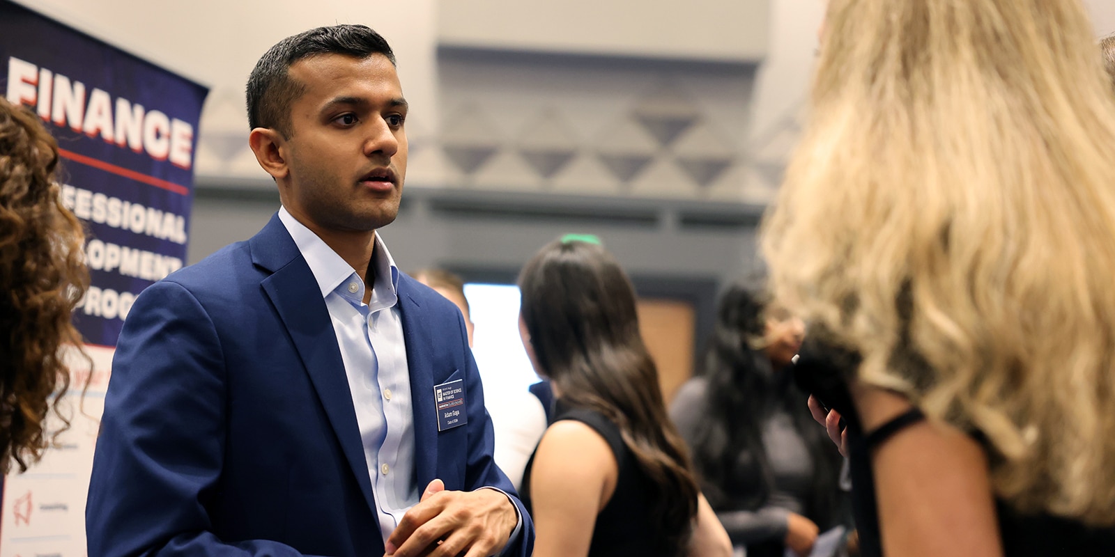 A male student speaking to a female recruiter. 