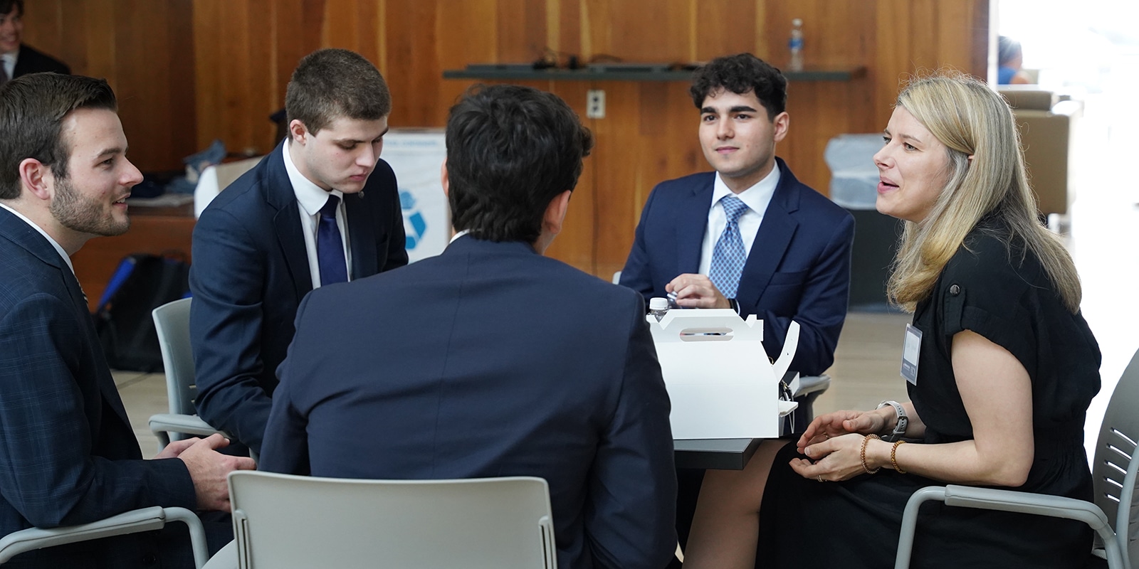 Group networking at the Finance Professional Development Program's Pitch Competition event. 