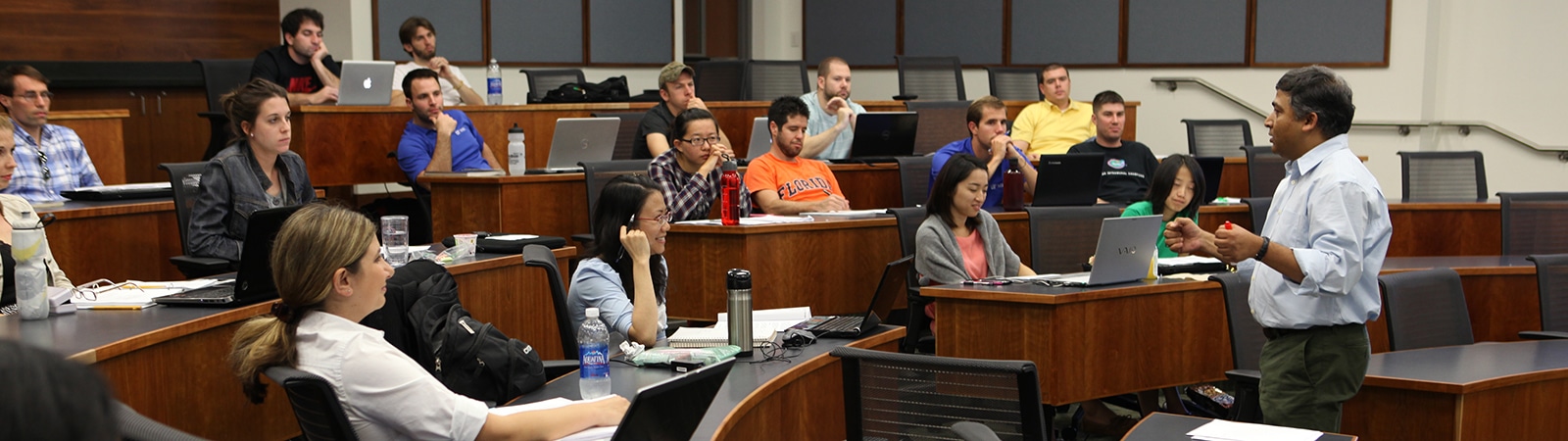 A professor lecturing to a classroom.