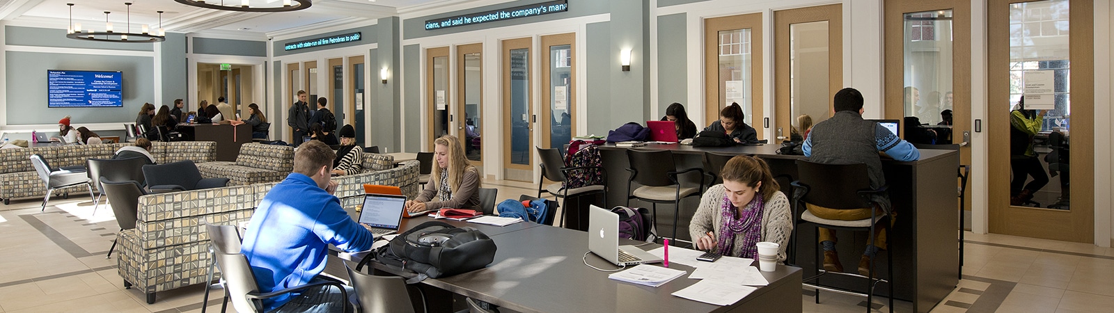 Students working in the Heavener Hall lobby. 
