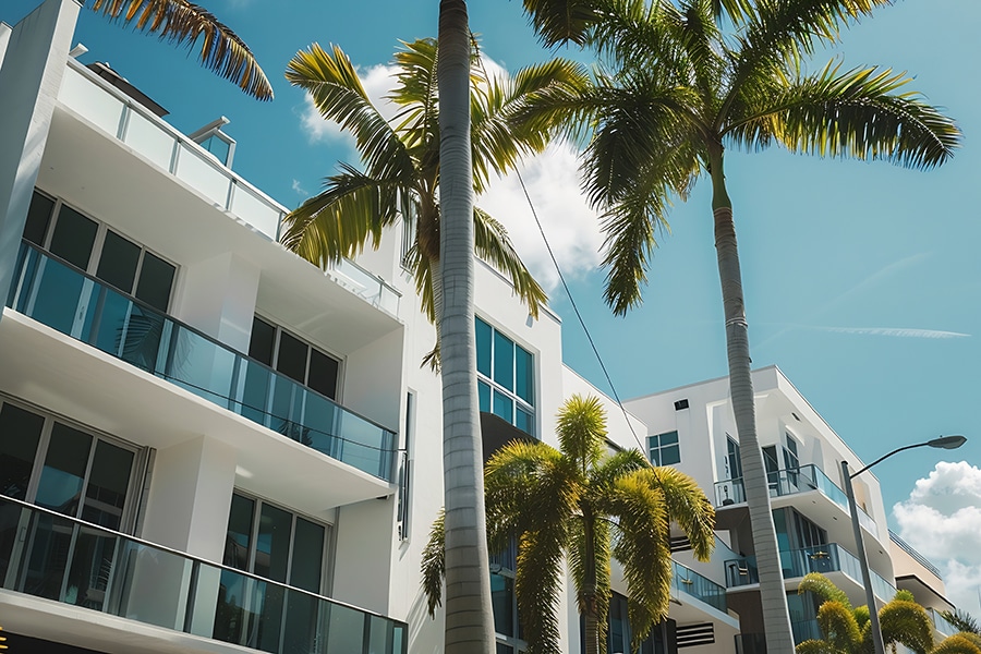 Modern apartment building with palm trees.