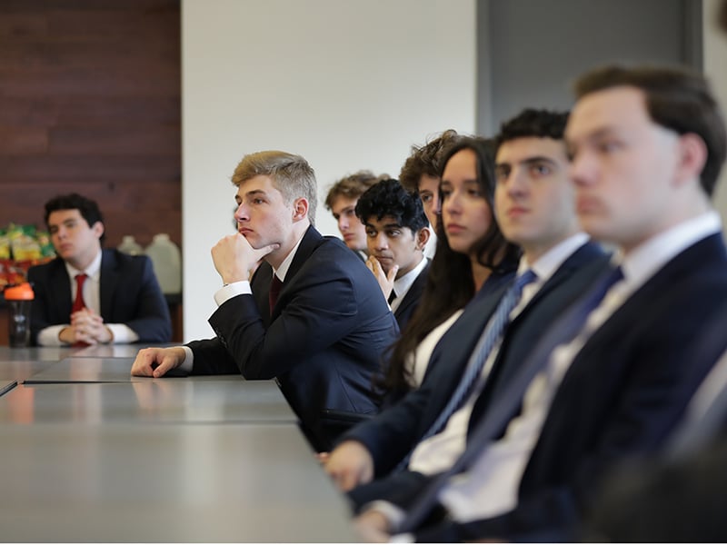 A student listening intently in an executive presentation. 