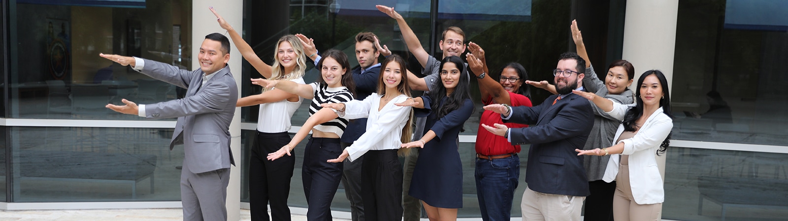 Group of Master of Science in Entrepreneurship students doing the Gator Chomp. 