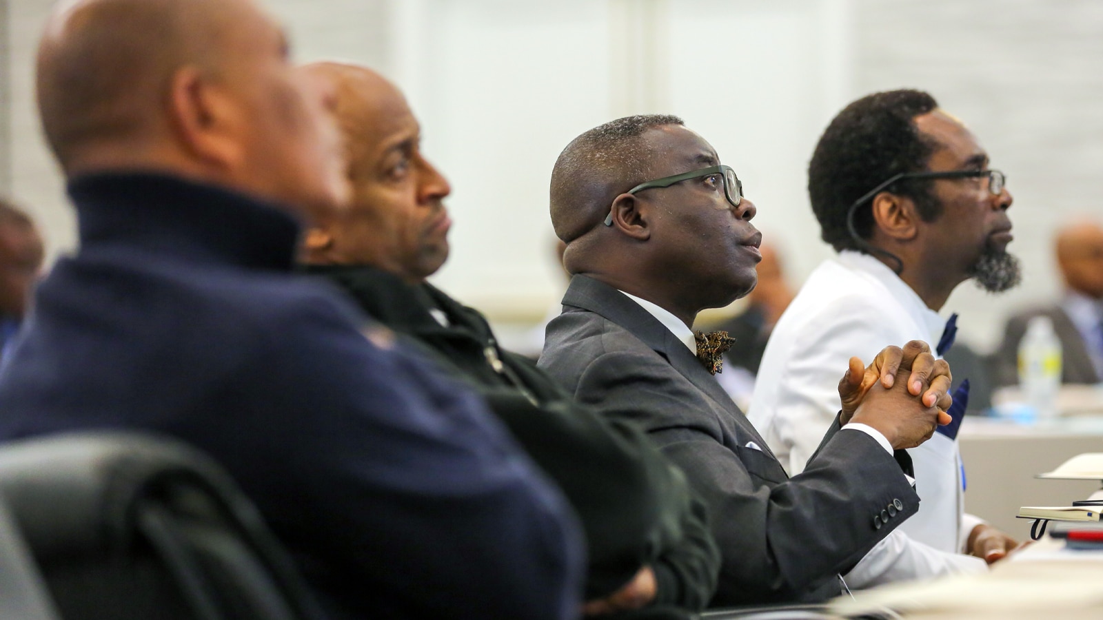 Audience members, dressed in business attire, attentively listen during a session at the PURC Annual Conference.