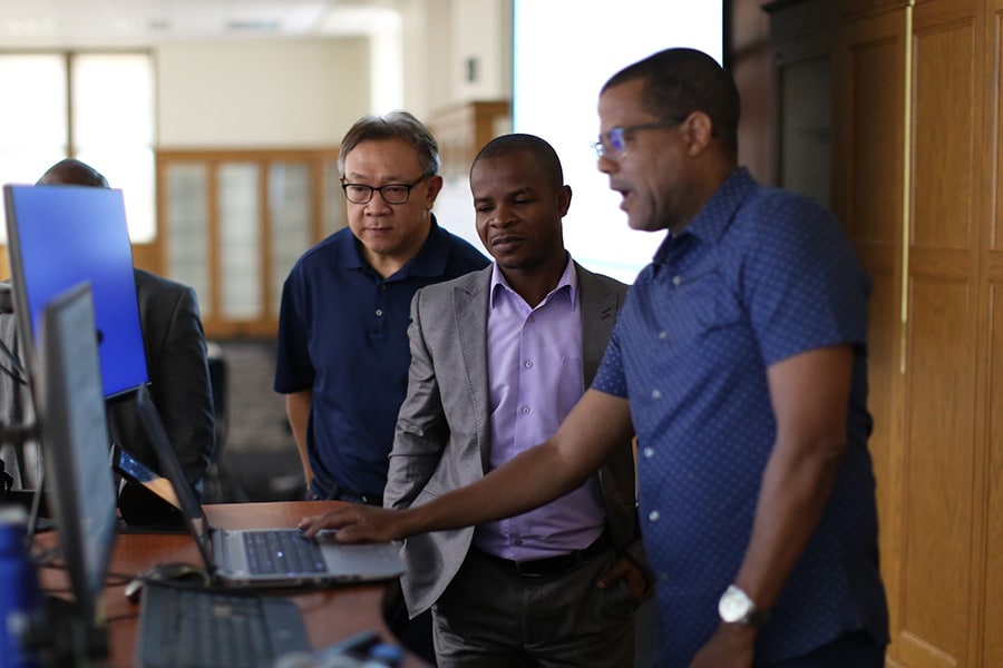 PURC presenters surrounding a computer.