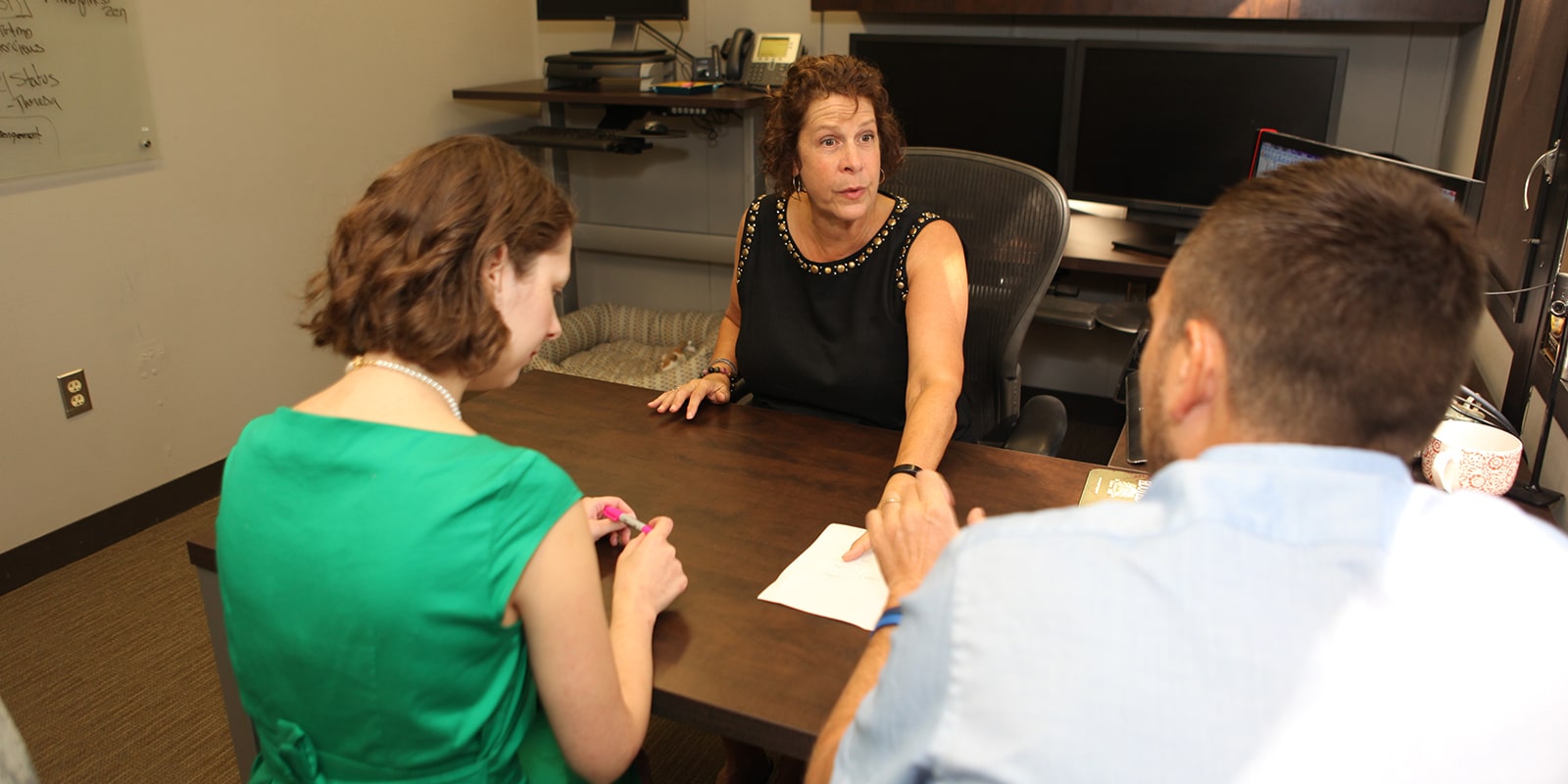 A professor meets with first-year students from UF Warrington's PhD in Management program about their research