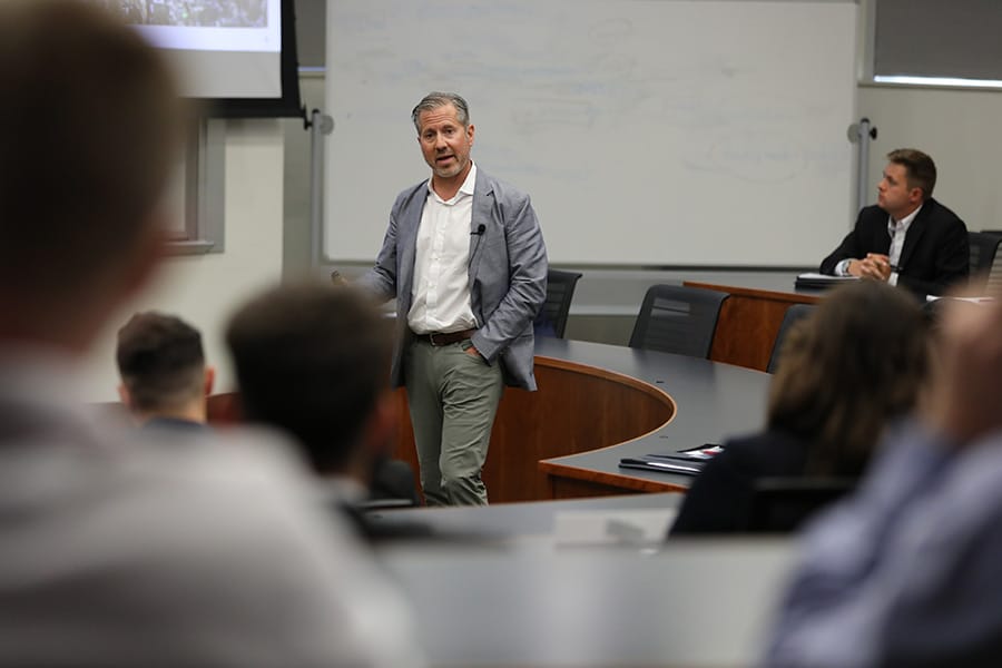 Aaron Wessner, real estate professional, speaking to Real Estate students in a classroom.