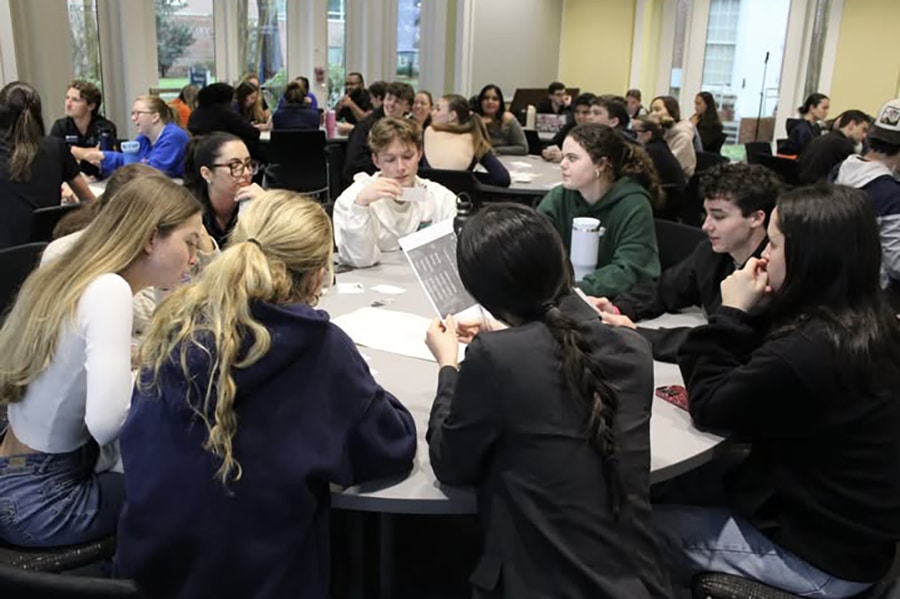 Students around a table working together.