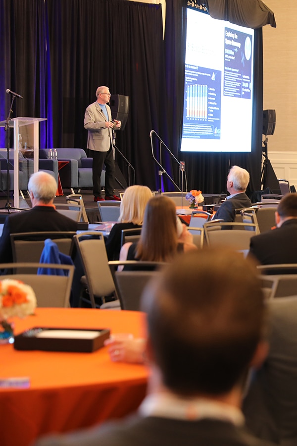 Speaker on stage at the UF Bergstrom Center Real Estate Trends & Strategies Conference. 